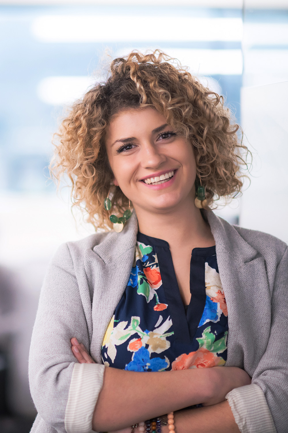 Portrait of female administrator with a curly hairstyle at an office