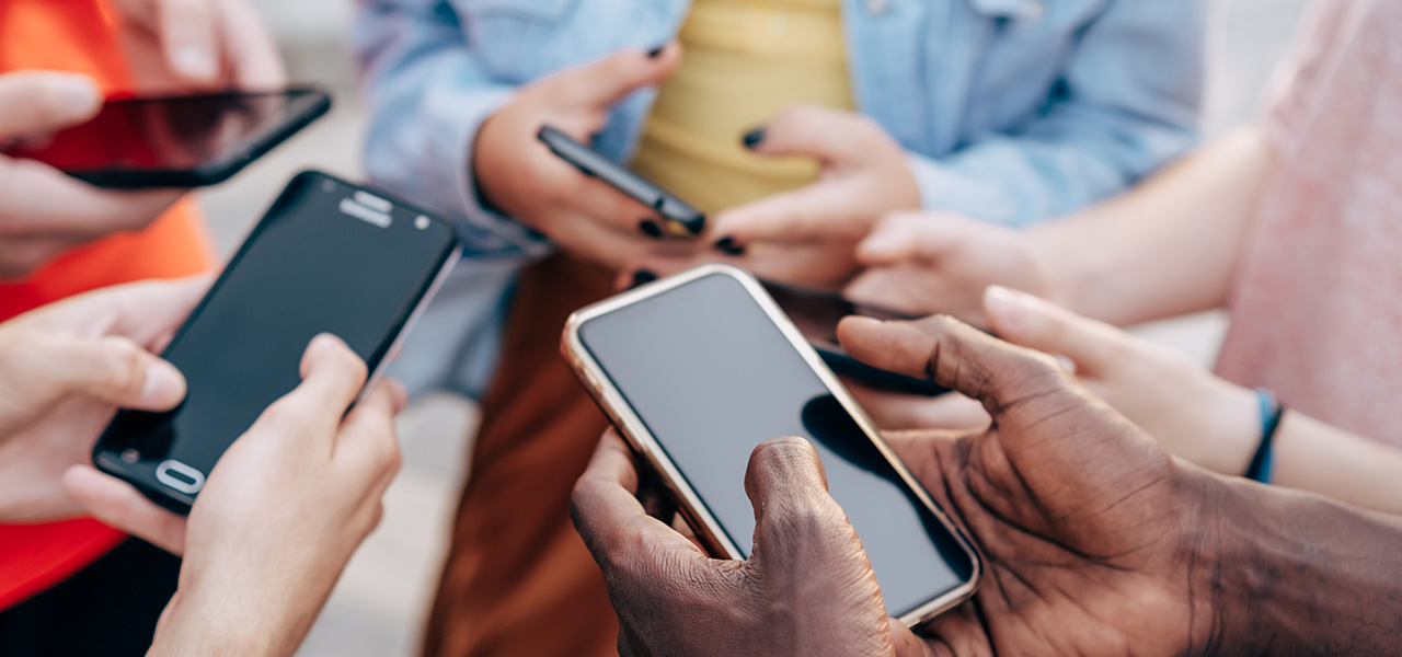 Close up of young multi-racial people using smartphones - Detail